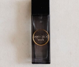 Jimmy Choo Man cologne bottle with black cap, viewed from above on a light surface—ideal for a stylish Gulf South wedding.