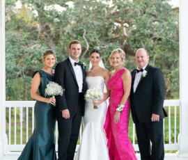 Five people in formal wear pose on a porch with greenery—classic wedding inspiration for a New Orleans celebration.