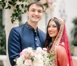 Smiling couple in traditional wedding attire with pink and white bouquet at their elegant Ritz-Carlton New Orleans wedding.