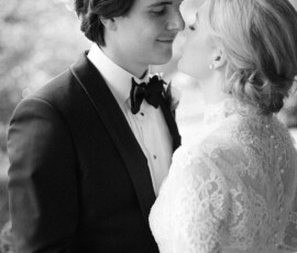 A bride and groom share a loving gaze at their New Orleans wedding at The Columns Hotel, in soft black and white light.