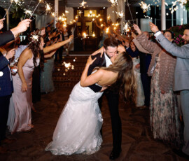Bride and groom kiss under a sparkler tunnel at night, perfect Louisiana wedding inspiration.