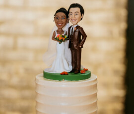 Wedding cake with textured white frosting and smiling bride and groom figurines, ideal for a Louisiana wedding.