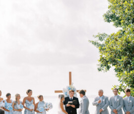New Orleans outdoor wedding with bride, groom, bridal party, and floral cross backdrop—stylish ceremony inspiration.
