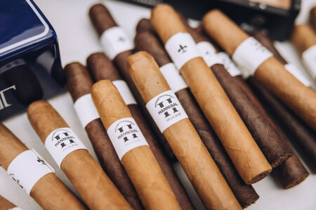 HANNIBAL-labeled cigars with light and dark wrappers are neatly arranged, offering elegant Gulf South wedding inspiration.