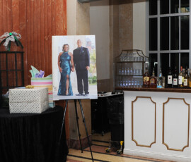 Bar area with bottles, gift table, and formal couple’s portrait—classic Louisiana wedding reception inspiration.