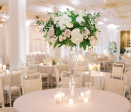 Elegant Gulf South wedding reception table with white and pink flowers, candles, white chairs, and romantic decor.