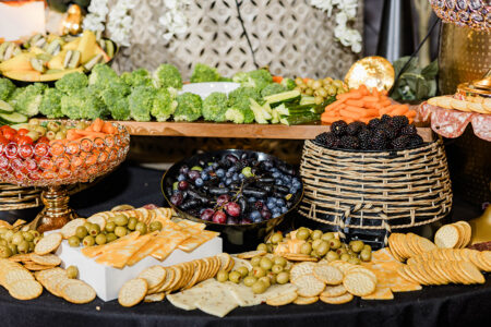 Assorted cheeses, crackers, fruits, and veggies artfully arranged for a stylish Gulf South or Louisiana wedding.