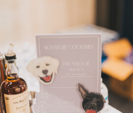 Signature Cocktails menu with dog illustrations, drinks The Maggie and The Vinnie, plus bottles—chic Louisiana wedding inspo.