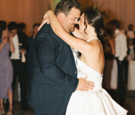 Bride and groom enjoy their first dance at Battle House Mobile wedding as guests watch and celebrate.