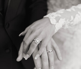 Close-up of a couple’s hands, showcasing an engagement ring and wedding band at their elegant Cathedral Basilica Mobile wedding.