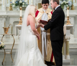 Bride and groom exchange vows at a decorated church altar, inspired by classic New Orleans wedding style.
