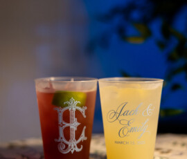 Personalized wedding cups—one red, one yellow—sit on a patterned surface, celebrating Jack & Emily’s March 15, 2025 Gulf South wedding.