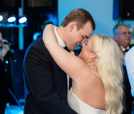 Bride and groom share a joyful embrace and smile on the dance floor at their Louisiana wedding reception.