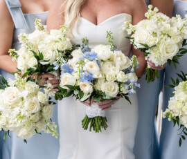 Bride in white dress with white and blue bouquet, bridesmaids in pale blue holding matching bouquets—Louisiana wedding inspiration.