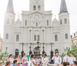 Outdoor Gulf South wedding at a cathedral with bride, groom, lavender bridesmaids, groomsmen in suspenders, and guests.