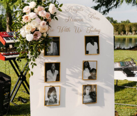 Wedding memorial display with six photos, flowers, and “Angels from Heaven” sign at Gulf South reception.