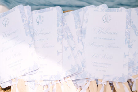 Elegant light blue and white wedding programs with floral borders for Morgan Thomson & Cole Hobbs in Point Clear, Alabama.