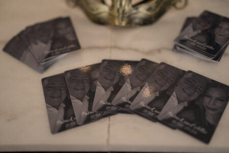 Black-and-white cards with smiling, formally dressed people on marble offer elegant New Orleans wedding inspiration.