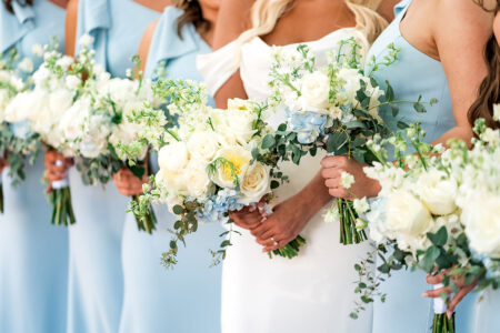 Bride in white with bridesmaids in light blue, holding white and pale blue bouquets—classic New Orleans wedding inspiration.